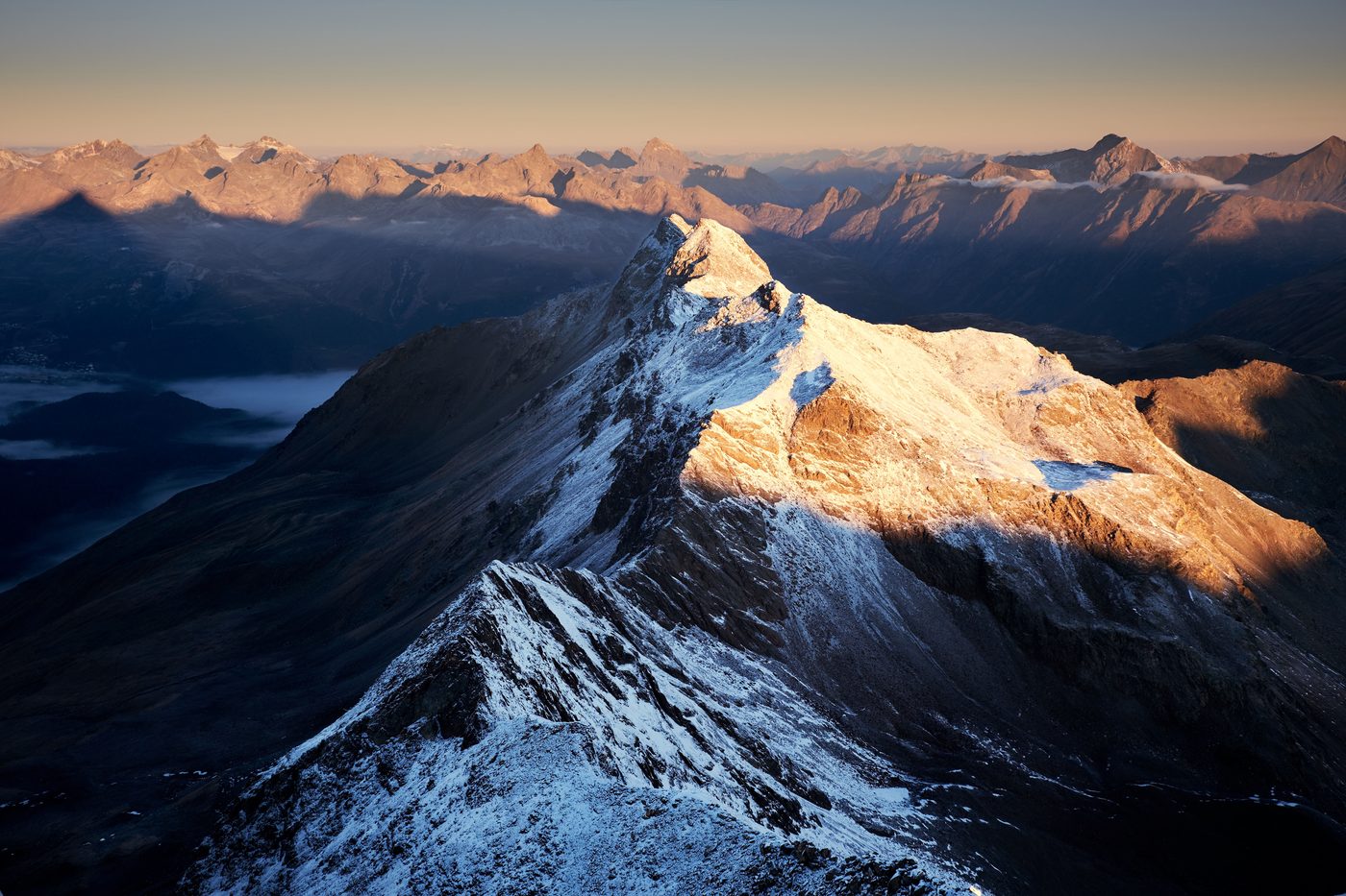 Aerial view of a vast snow covered mountain range